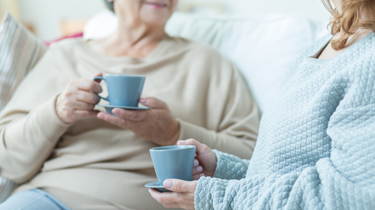 Photo of two people with coffee mugs